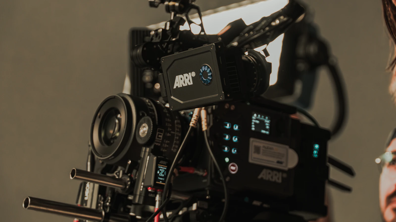 Professional cinema camera rig with a large lens and monitoring equipment.